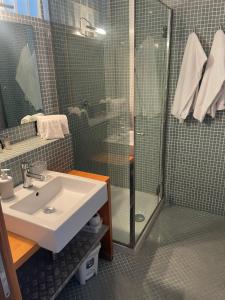 a bathroom with a sink and a shower at garibaldi citta' in Trapani +11 photos