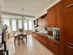 a large kitchen with wooden cabinets and a table in it at ENDLESS SUMMER in Gaeta