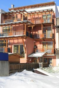 a building with balconies and snow in front of it at Appartement Hohe Mut in Obergurgl