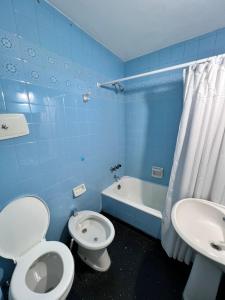 uma casa de banho azul com um WC e um lavatório em Abasto Lindo Dpto 2 Amb c Cocina Mantenemos Precio em Buenos Aires
