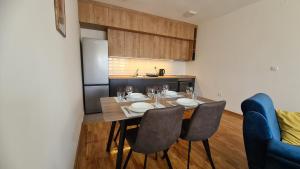 una cucina con tavolo e sedie in una cucina di Apartman Centar Bečej a Bečej