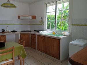 a kitchen with a sink and a window at ZEN SOUFRIERE in Saint-Claude +13 photos