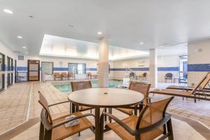 a lobby with a pool and tables and chairs at Courtyard Burlington Williston in Burlington