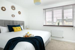 a bedroom with a large white bed and a window at KVM - Thorpe House in Peterborough +12 photos
