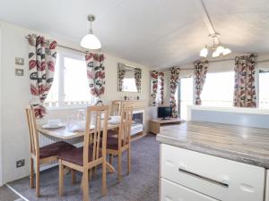a kitchen and dining room with a table and chairs at Swinside in Cockermouth
