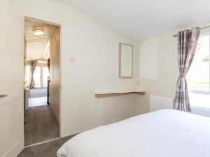 a bedroom with a white bed and a window at Swinside in Cockermouth