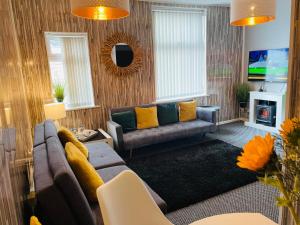 a living room with a couch and a tv at Holywell Apartment - Luxury One Bedroom Apartment in Holywell