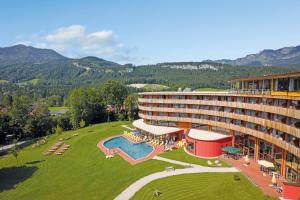 ein Hotel mit einem großen Garten mit Pool in der Unterkunft Vivea Hotel Bad Goisern in Bad Goisern