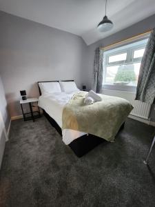 a bedroom with a large bed and a window at Fox Hollies Shared House in Birmingham