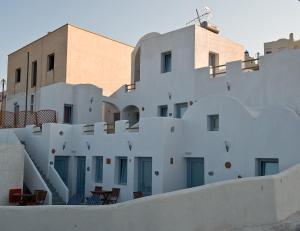 a white building with a large white building behind it at Villa Murano in Fira