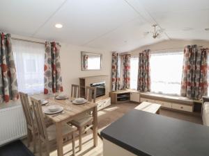 a dining room with a table and chairs at Rhodes Retreat in Cockermouth