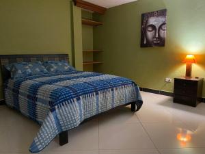 a bedroom with a bed and a picture of a woman at River house in Jardin