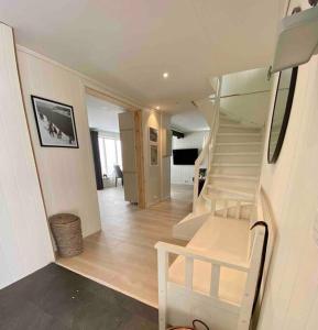 a white staircase in a house with a room at Fjordgård Mountain Aurora View in Fjordgård