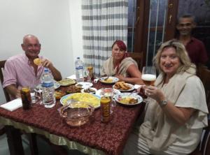 a group of people sitting at a table eating food at Galle Fantacy in Unawatuna +15 photos
