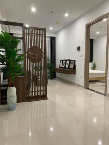 a lobby with a door with a potted plant at Nera House in Hue