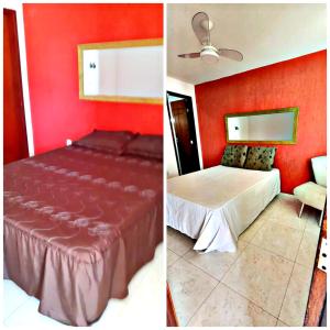 1 dormitorio con cama y pared roja en ALUGO CASA INTEIRA EXCELENTE Casa de temporada em Cabo Frio, en Cabo Frío