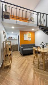 a living room with a couch and a table at VANIA HOUSE - cozy studio near the airport in Ho Chi Minh City