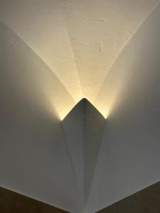 a light on the ceiling of a white wall at Hotel Villa Cedrino in Dorgali