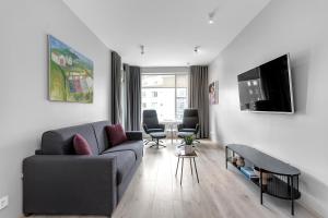 a living room with a couch and a tv at Tower Apartments in Reykjavík