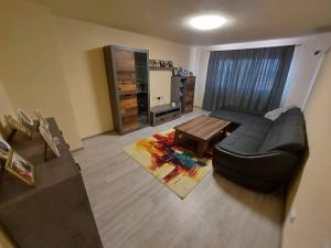 a living room with a couch and a table at Apartament Blaj in Blaj