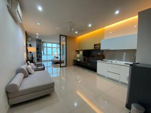 a large living room with a couch and a kitchen at Cozy Twin Galaxy Studio Netflix 4 Pax JB City in Johor Bahru