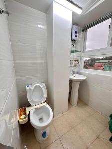 a bathroom with a toilet and a sink at Zenmist properties - Studio Unit in Baguio
