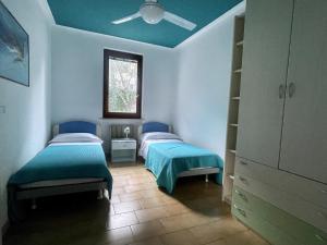 - 2 lits dans une chambre dotée d'un plafond bleu dans l'établissement Casa Tuly 1, à Brenzone