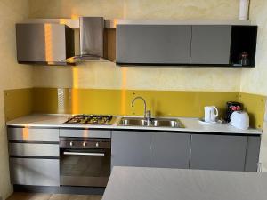 a kitchen with a sink and a stove at Casa Tuly 1 in Brenzone sul Garda