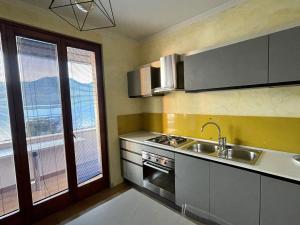 a kitchen with a sink and a stove and a window at Casa Tuly 1 in Brenzone sul Garda