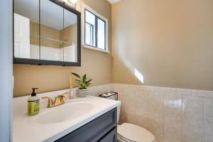 a bathroom with a sink and a toilet and a mirror at Serene Pocono Pines Home 2 Mi to Lake Naomi Beach in Pocono Pines +23 photos