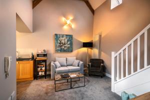 a living room with a couch and a table at Swan Mews in Wells