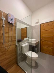 a bathroom with a toilet and a sink and a shower at VangVieng Crystal Boutique Hotel in Vang Vieng