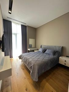 a bedroom with a bed and a large window at Lighthouse, Sea Breeze in Baku