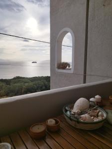 a balcony with a window with a view of the ocean at Indigo in Rafina