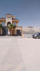 a house with a car parked in a parking lot at Al Narjes Villas & Apartments in Riyadh