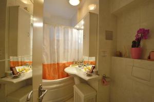 a bathroom with two sinks and a shower and a tub at Atlas Accommodation Studio Romana de Lux in Bucharest +25 photos