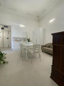 a living room with a table and chairs and a couch at Cutelli Gold in Catania