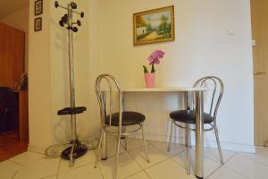 a table and two chairs in a room at Atlas Accommodation Studio Romana de Lux in Bucharest