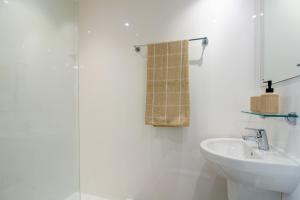 a white bathroom with a sink and a mirror at For Students Only Ensuite Bedrooms at Westwood Student Mews in Warwick in Coventry