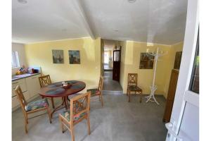 a kitchen and dining room with a table and chairs at Ferienhaus Dorfstrasse 12a in Loddin