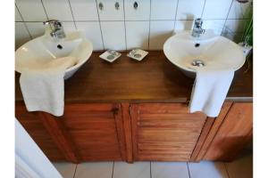 two sinks in a bathroom with two towels at Ferienbungalow Waldstrasse in Ueckeritz