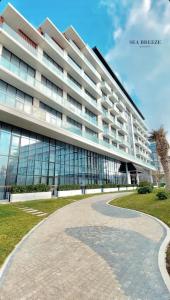 a large building with a walkway in front of it at Lighthouse, Sea Breeze in Baku