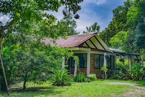 a small house with a red roof at Casa Finca Villa Cristal in Popayan