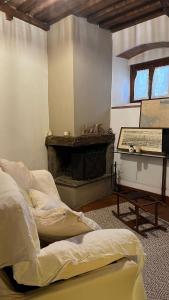 a living room with two beds and a fireplace at La cicala in Rosignano Marittimo