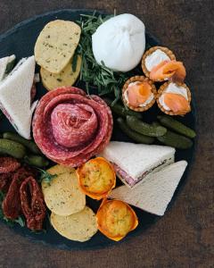 a plate of different types of sandwiches and vegetables at Kairos Resort & SPA in Piedimonte San Germano