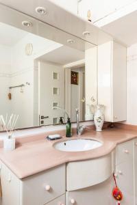 a bathroom with a sink and a large mirror at Cosy room near IDC & Center- Herzliya Homestay in Herzelia 