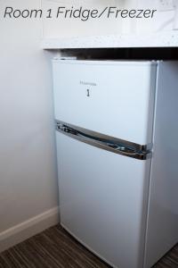 a white refrigerator freezer sitting in a kitchen at Town House Chantry - With Self Check In and Free Parking - Rooms at ipswichdigs in Ipswich