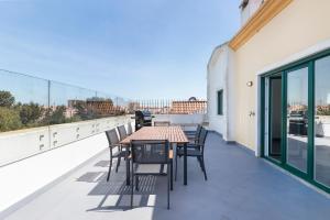 a patio with a table and chairs on a balcony at Cascais Duplex Apartment in Cascais
