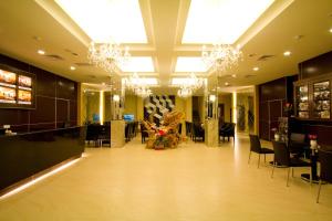 a salon with chandeliers and tables and chairs in a building at Formosa Vacation Village Homestay in Renai