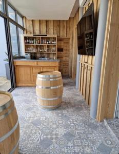 a wine tasting room with barrels and a bar at Lamarck Guest in Bourges